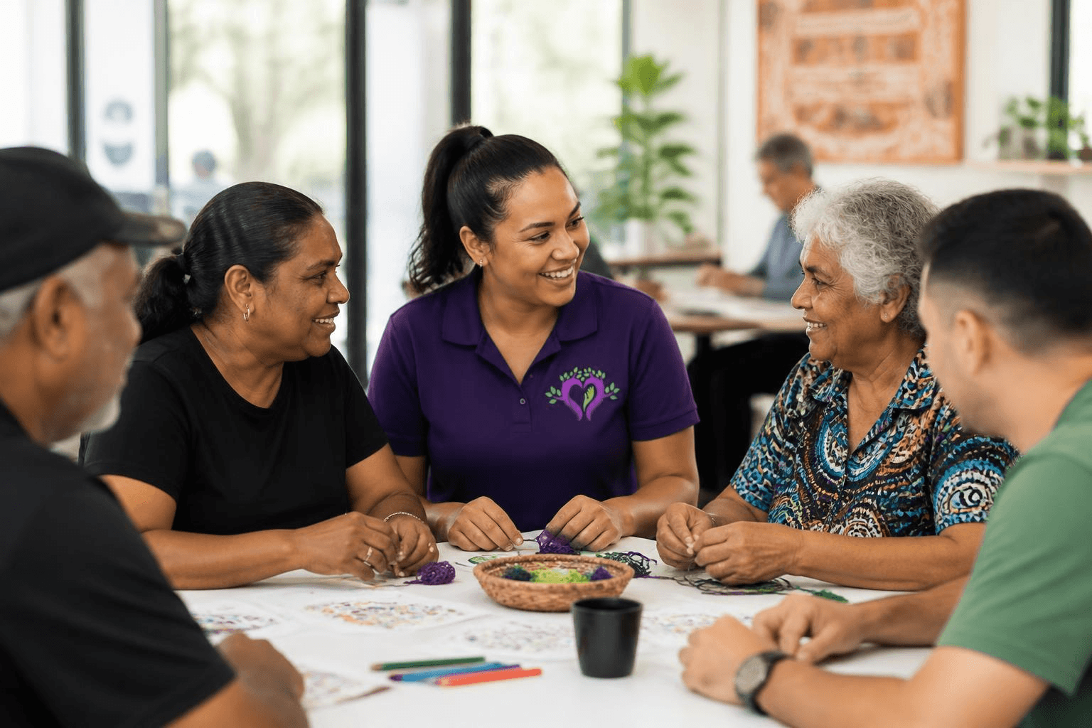 Support worker and participant engaging in a group learning session